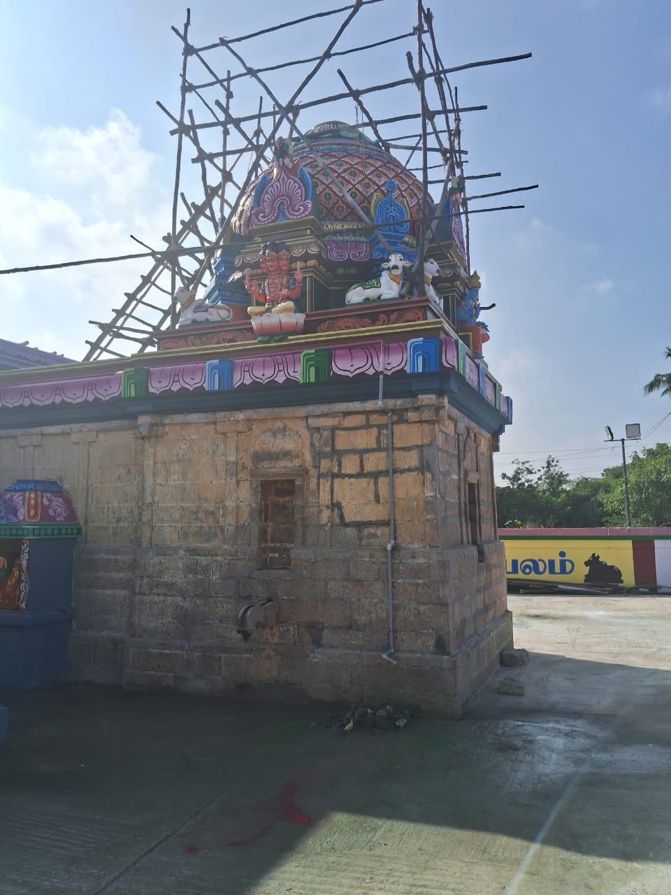 Brass lamps arranged in temple pathway